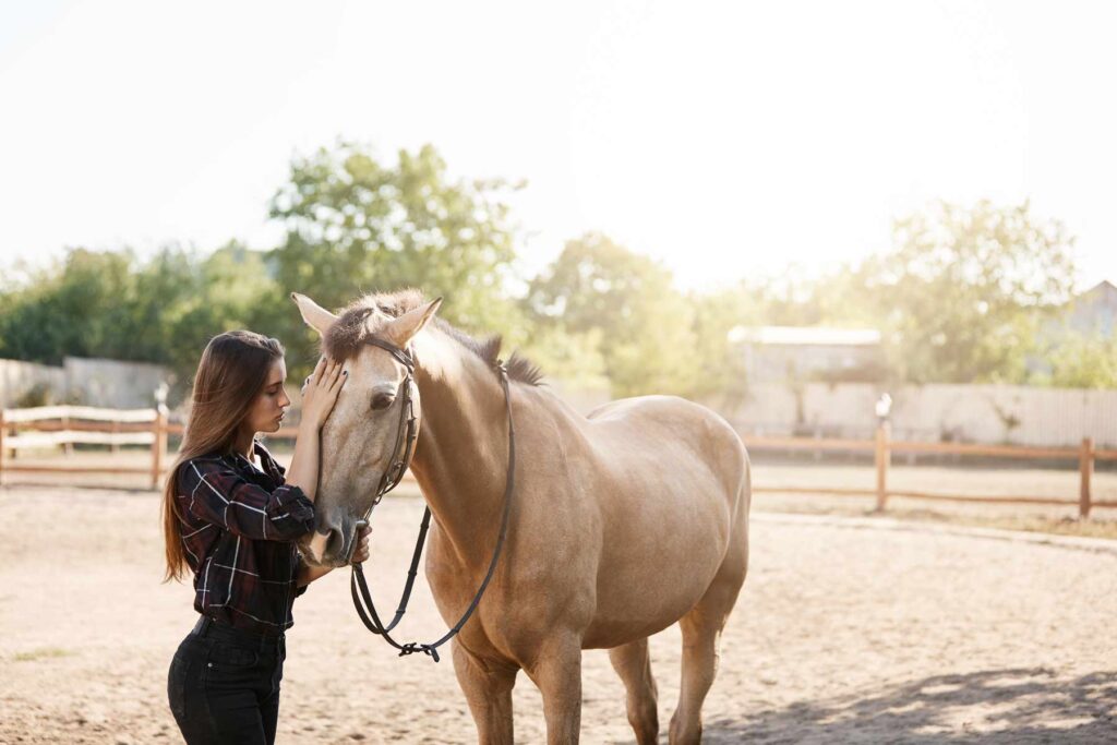 Young female horse owner taking a walk with an animal on a farm or ranch Freedom