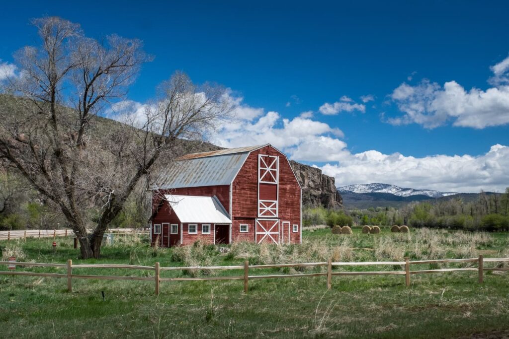 Beautiful shot of the red wooden barnyard in the field