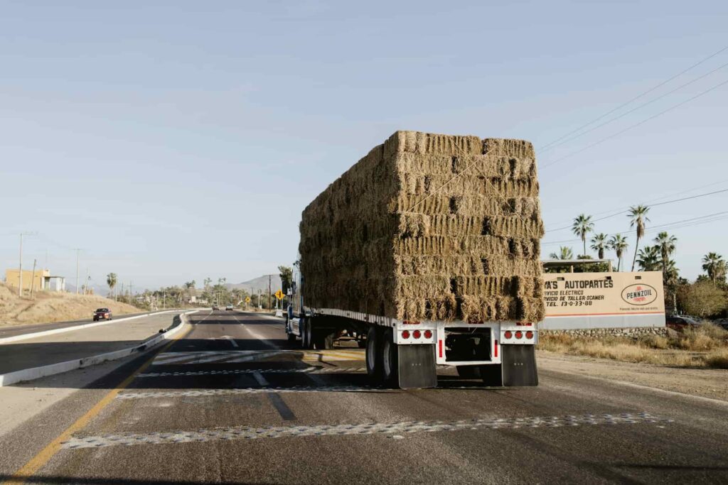 Semi truck transporting Hay on the road